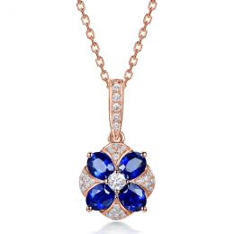 Pendentif solitaire fleur bleue. Or rose, saphirs et diamant